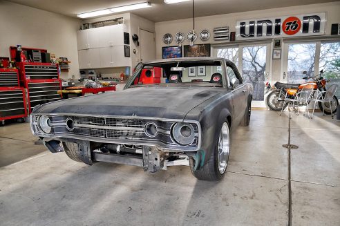 Primered Dodge Challenger at shop getting restored