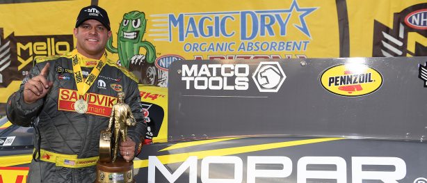 Matt Hagan holding up a Wally trophy after winning NHRA Arizona Nationals