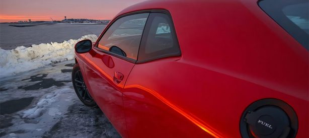 Side view of red Dodge Challenger AWD