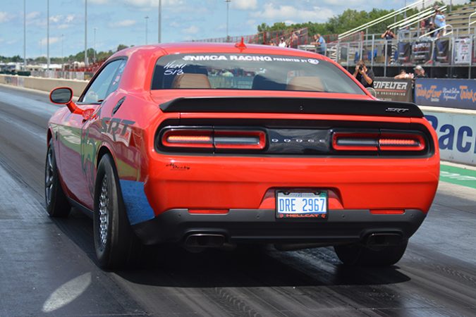 dodge vehicle racing down a drag strip