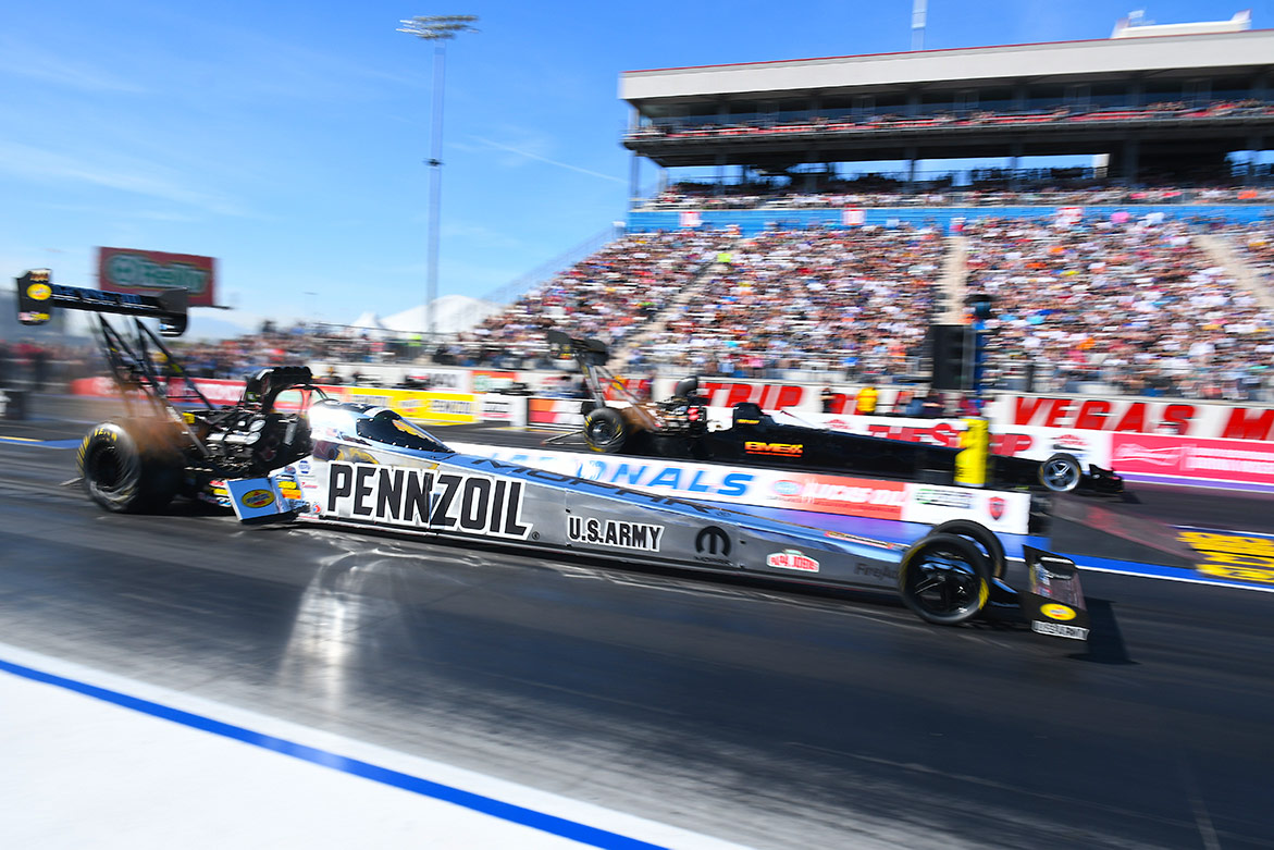 top fuel dragsters on the starting line of a drag strip