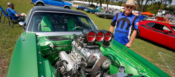 man posing with a vehicle