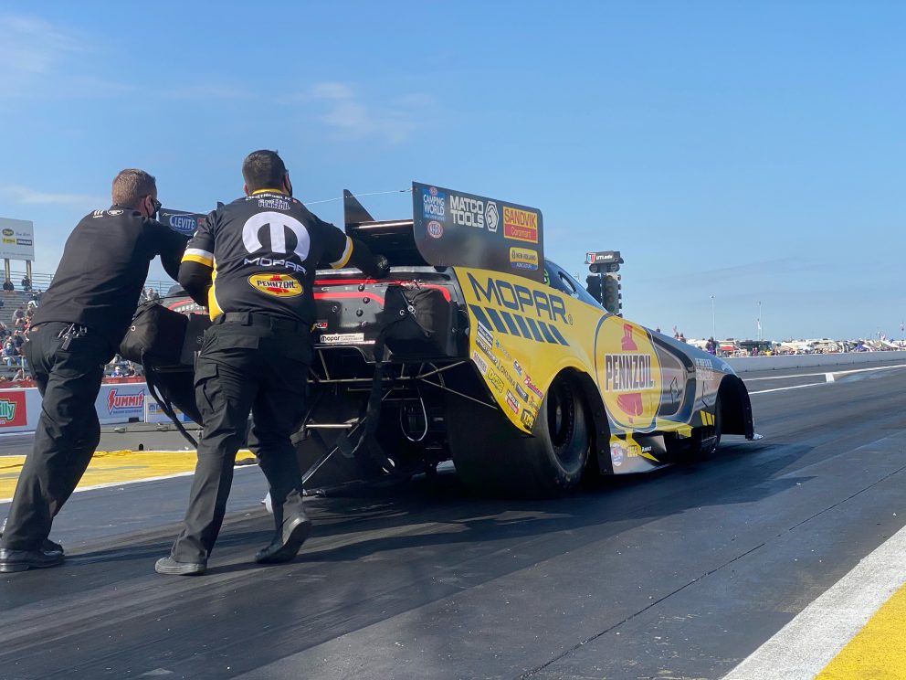 Matt Hagan's crew pushing his funny car to the start line