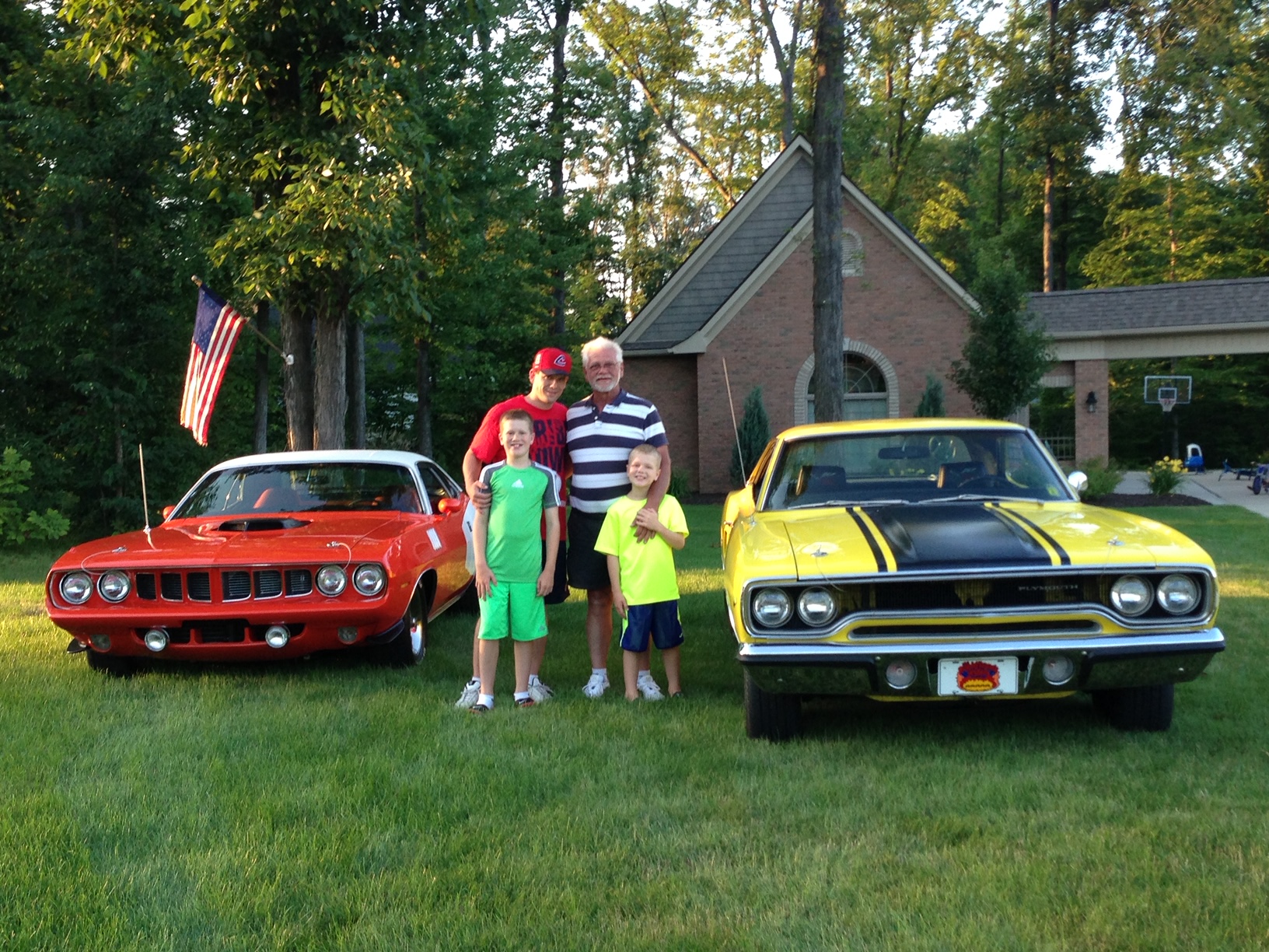 Raymond, Brian, Zachary, Dominic, orange 1971 Plymouth Cuda and yellow 1970 Plymouth Road Runner with black hood stripes