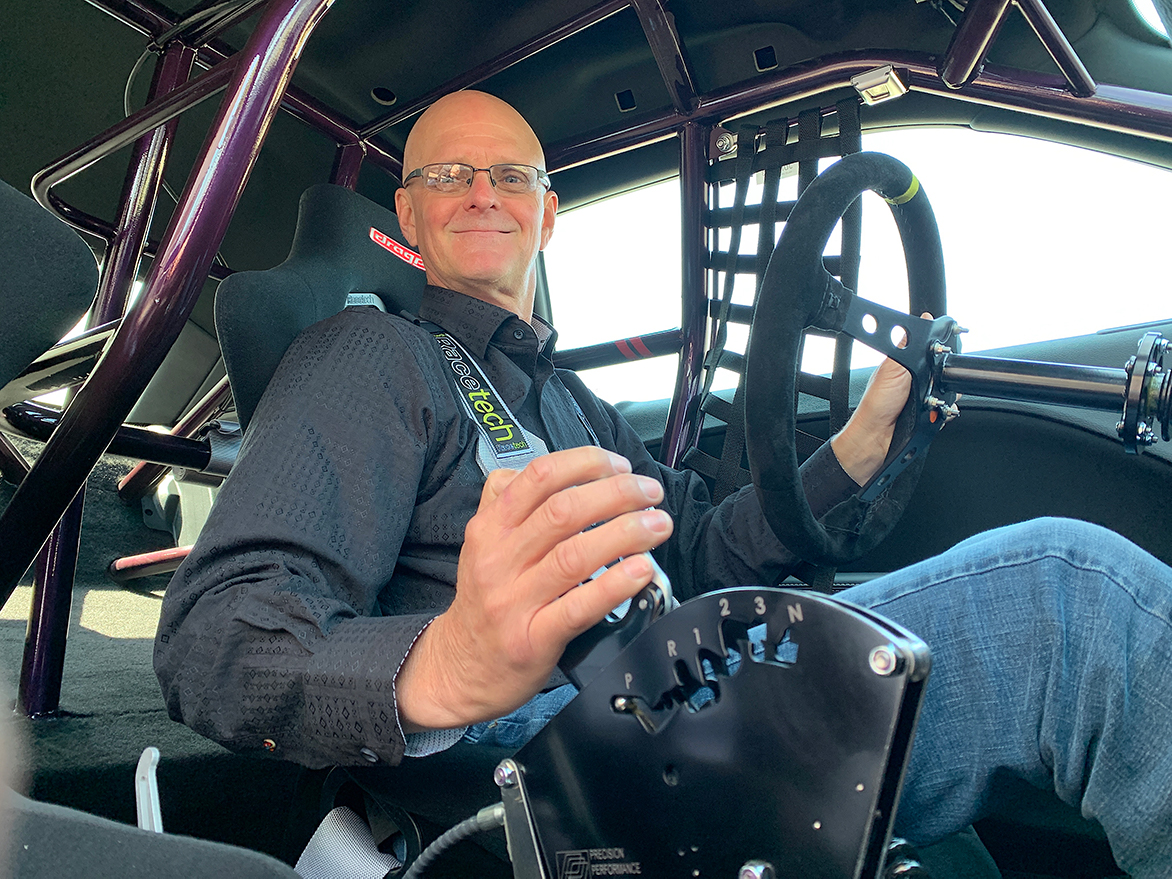Man in the driver's seat of his 2021 Dodge Challenger Mopar Drag Pak