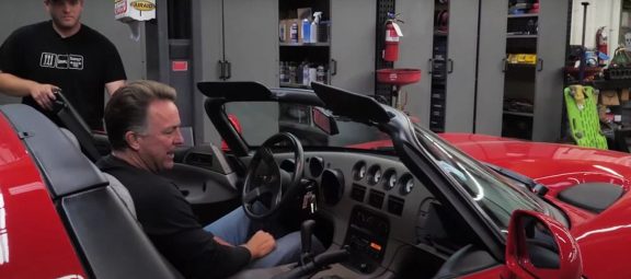 Man sitting in a Dodge Viper