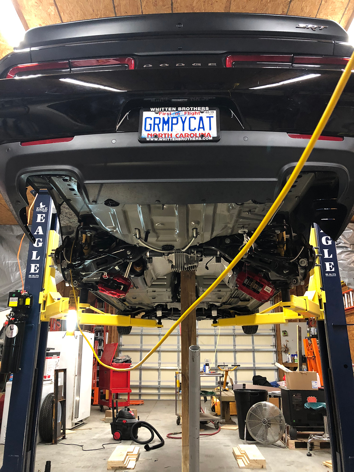 Dodge Challenger lifted in a garage
