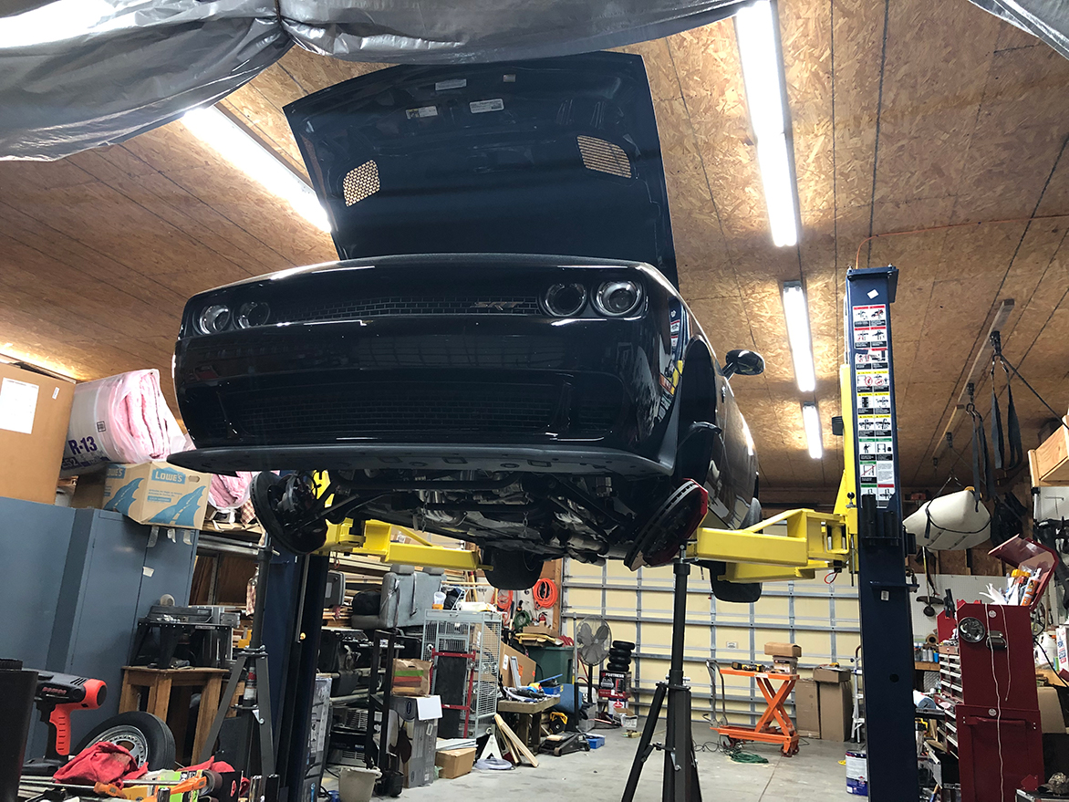 Dodge Challenger lifted in a garage