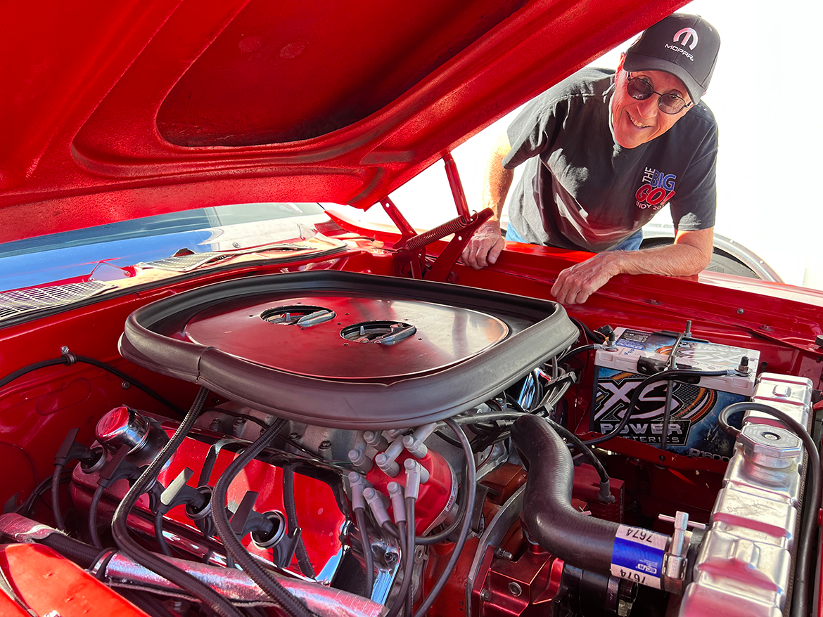 Man with a vehicle engine