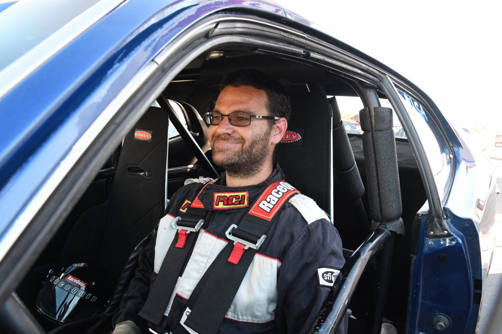 man sitting inside a race car