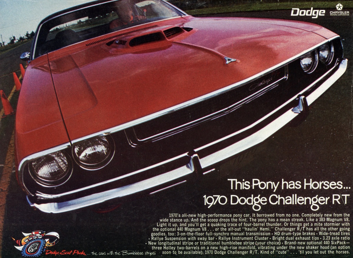 Low-angle view of a red 1970 Dodge Challenger RT parked outdoors, showcasing its front grille and headlights. The car is positioned diagonally, with orange cones visible in the background and promotional text overlayed.