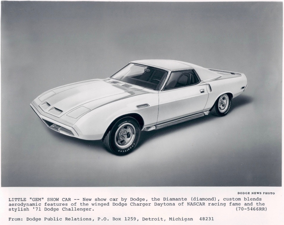A white 1971 Dodge Diamante concept car is shown in a studio setting. The car features a sleek, aerodynamic design with a long hood, two doors, and prominent wheel arches.
