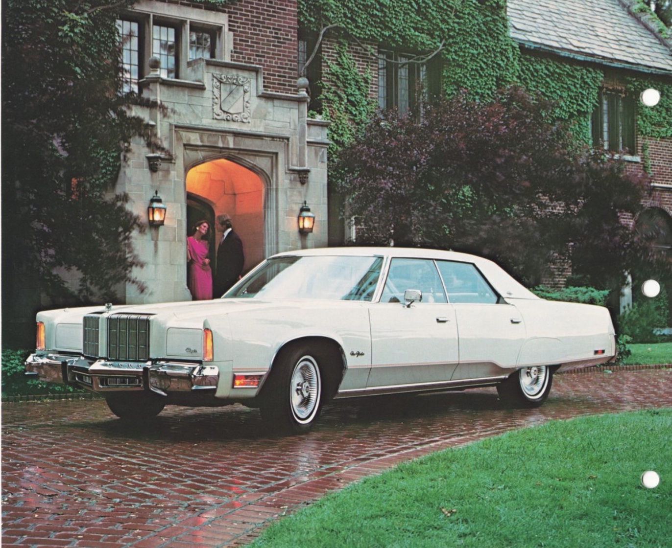 A white vintage car is parked on a brick driveway in front of an ivy-covered mansion. Two people are talking near the entrance under a lit archway. Lush green grass and trees surround the scene.