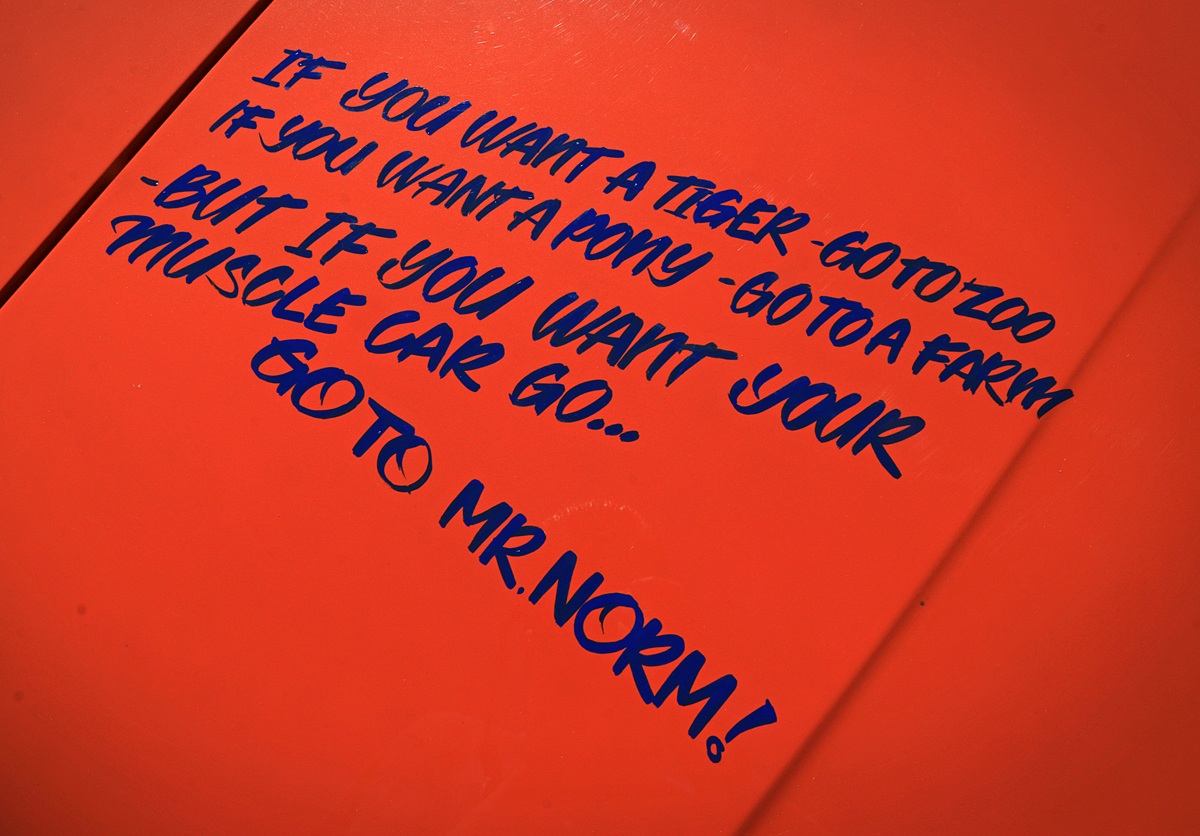 Handwritten blue text on an orange background reads: If you want a tiger go to zoo, if you want a pony - go to a farm, but if you want your muscle car go… go to Mr. Norm!.